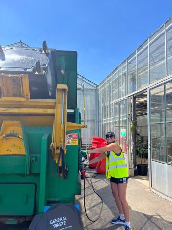 Crew Member Using Compactor