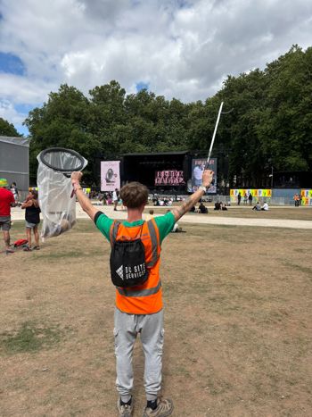 Crew Member Raising Bin Bag And Litter Pick In The Air Wearing Dc Bag