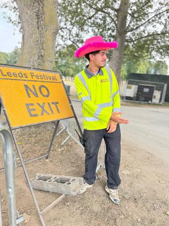 Crew Member Directing Taffic By No Exit Sign