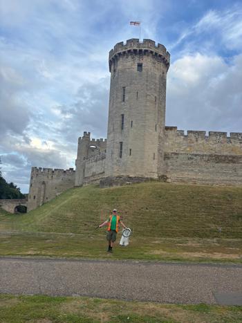 Crew Member Infront Of Castle