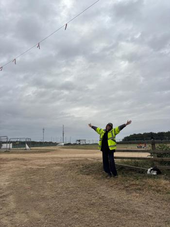 Crew Member Smiling With Arms In Air